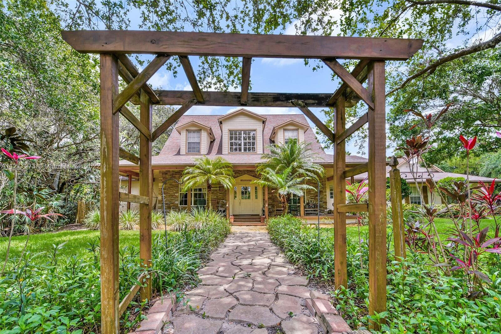 14425 North 64th Court North Loxahatchee, FL 33470 - Photo 3 of 36 a front view of a house with a porch