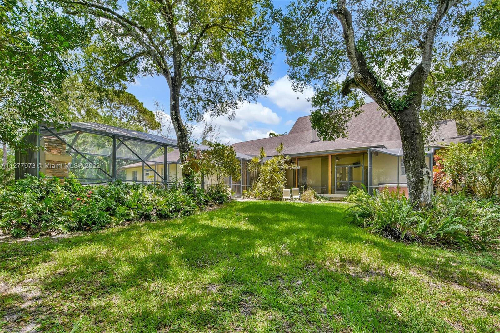 14425 North 64th Court North Loxahatchee, FL 33470 - Photo 33 of 36 a front view of a house with garden