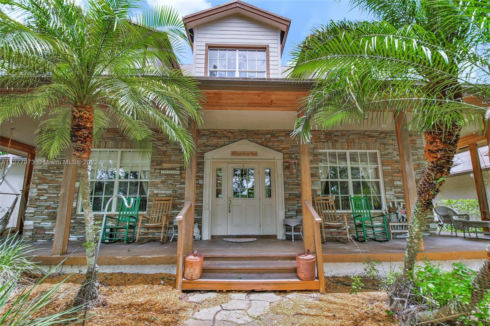 14425 North 64th Court North Loxahatchee, FL 33470 - Photo 4 of 36 a front view of a house