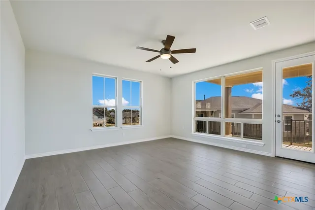 a view of a kitchen with stainless steel appliances wooden floor and a large window