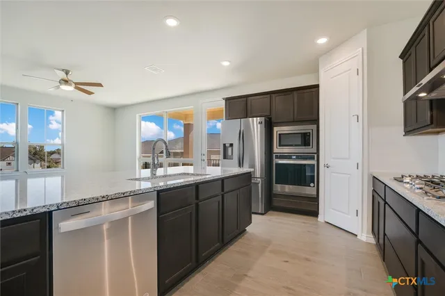 a kitchen with granite countertop a sink and stove
