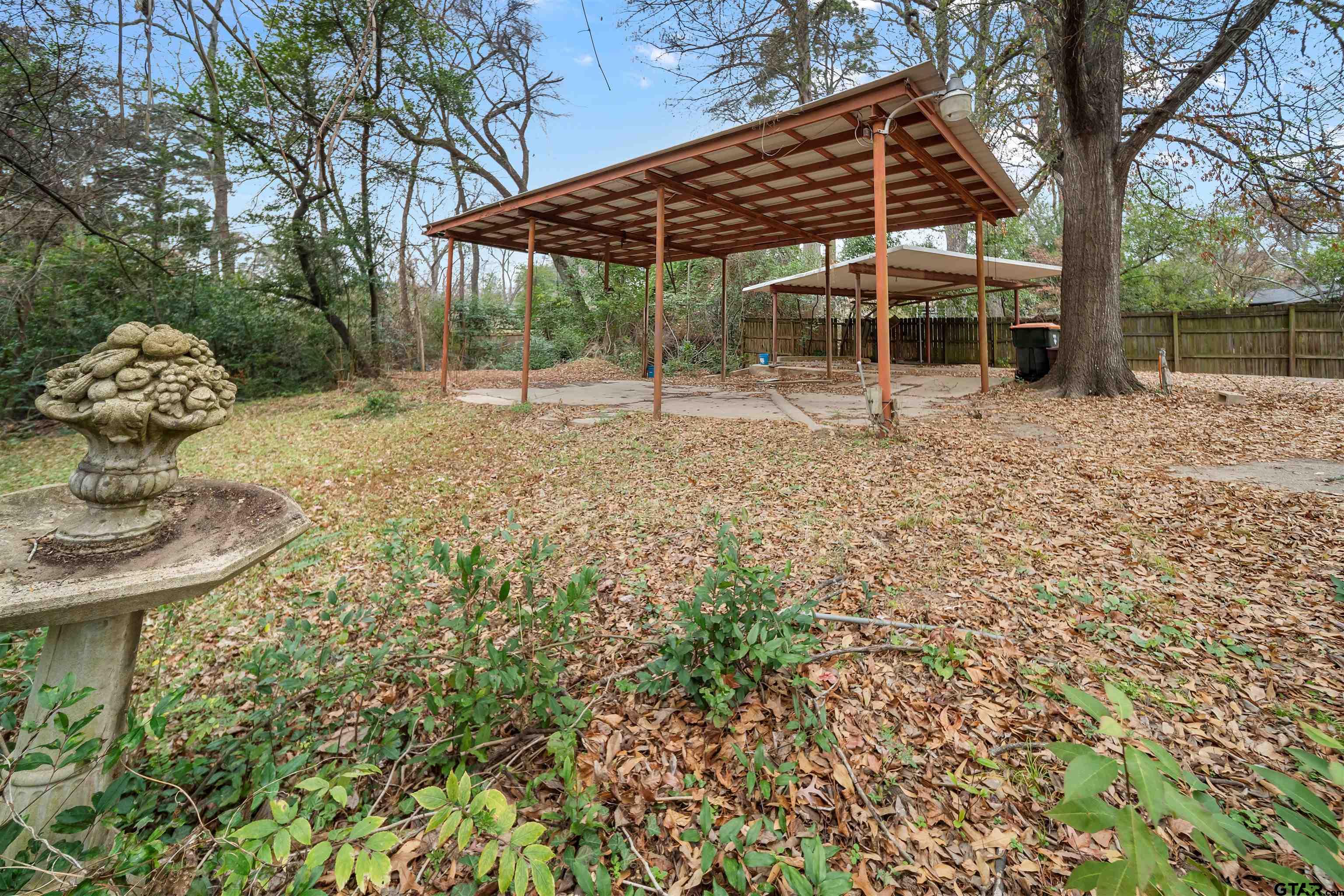 2521 Pounds Tyler, TX 75701 - Photo 34 of 40 a backyard of a house with table and chairs under an umbrella