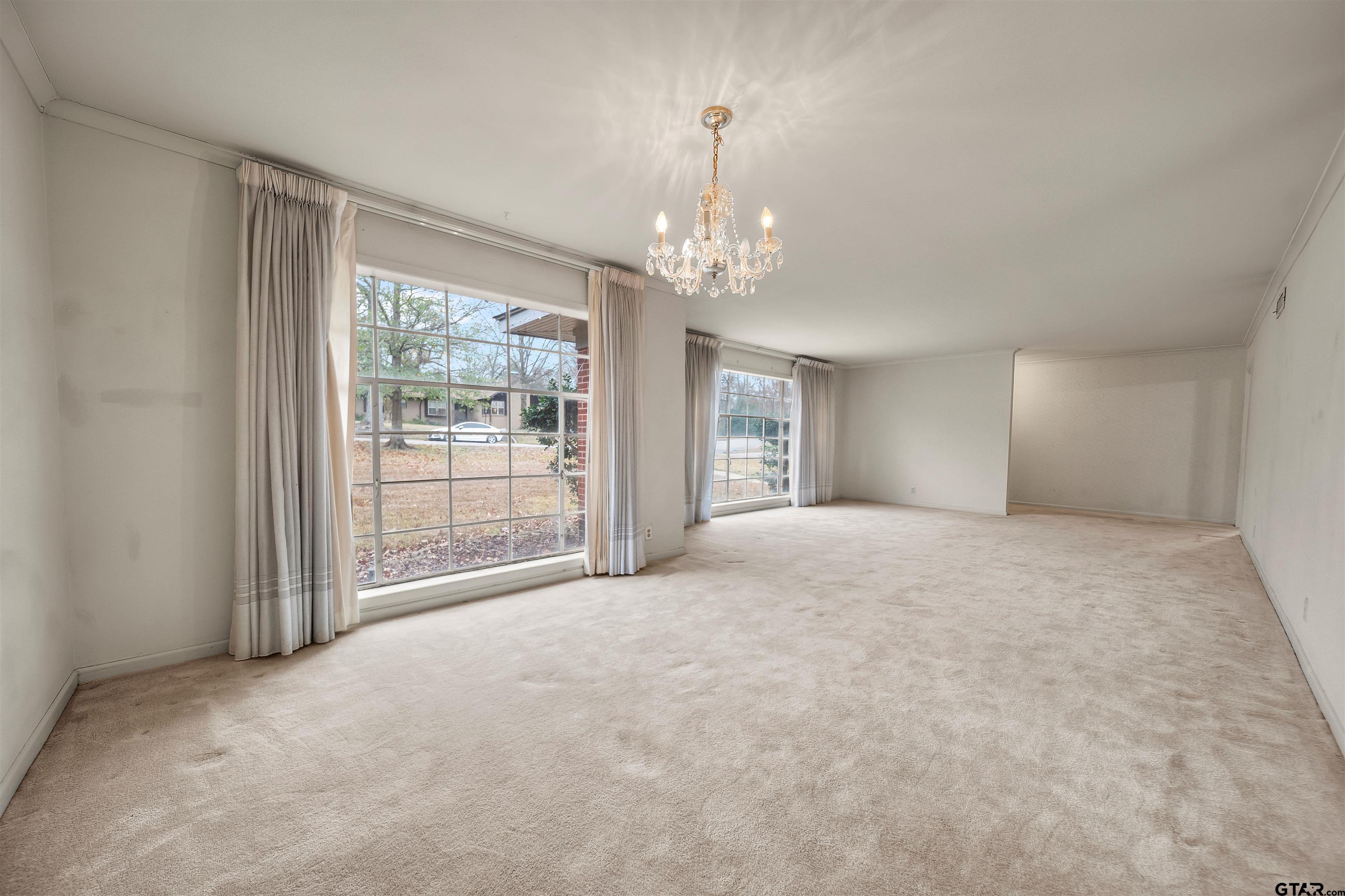 2521 Pounds Tyler, TX 75701 - Photo 5 of 40 a view of an empty room with windows and chandelier