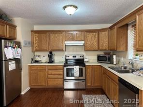 324 Capitol Avenue Waterbury, CT 06705 - Photo 8 of 32 a kitchen with stainless steel appliances granite countertop a stove a sink and a refrigerator