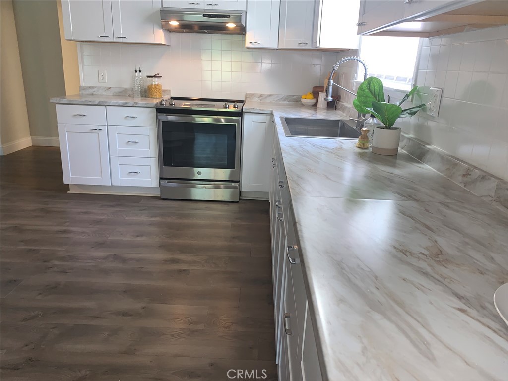 11092 East Highway 20 Lucerne, CA 95423 - Photo 8 of 27 a kitchen with granite countertop a sink stainless steel appliances and cabinets