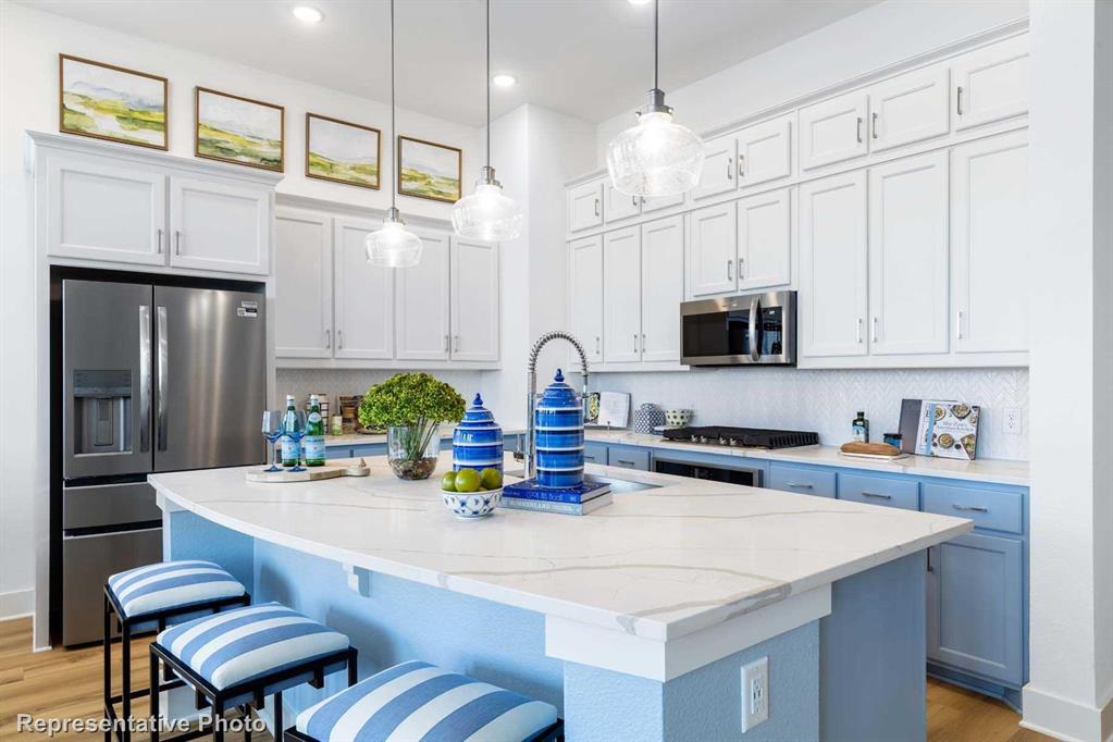 a kitchen with stainless steel appliances a sink and a refrigerator