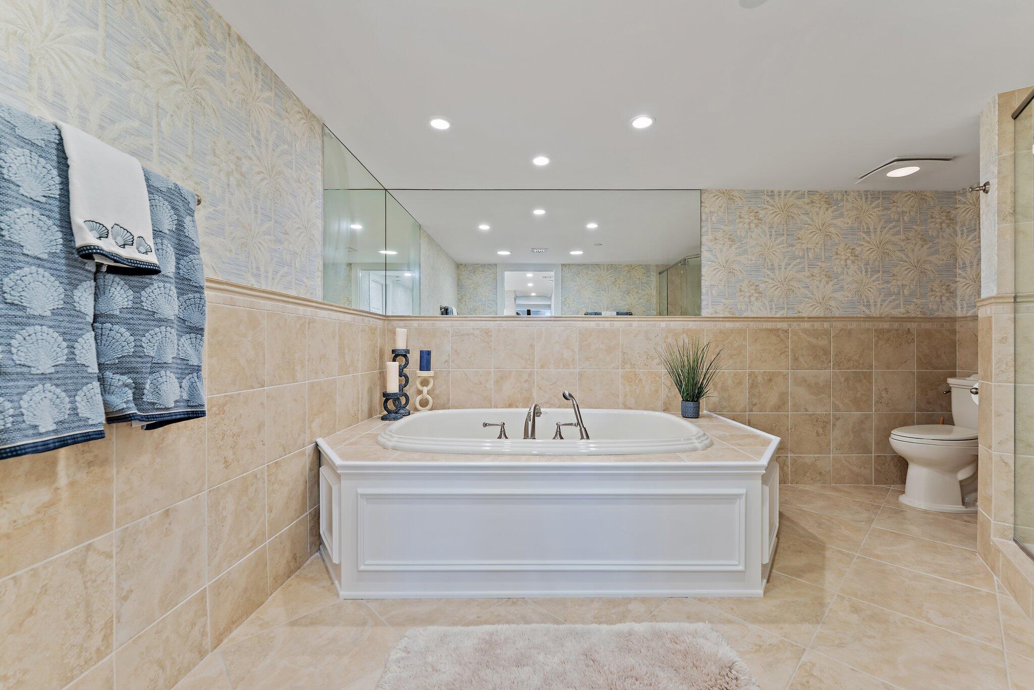 19670 South Beach Road, Unit B303 Jupiter, FL 33469 - Photo 37 of 104 a bathroom with a sink a toilet and a bathtub