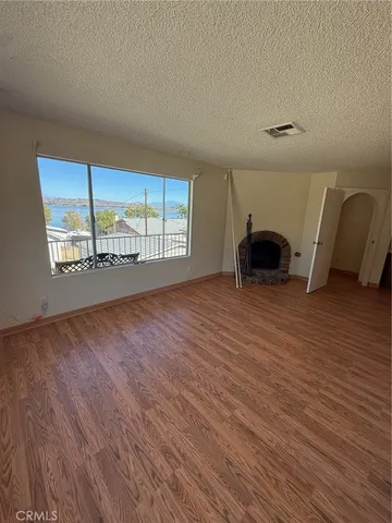 a view of a room with wooden floor