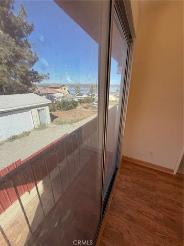 a view of roof deck with two chairs and wooden floor