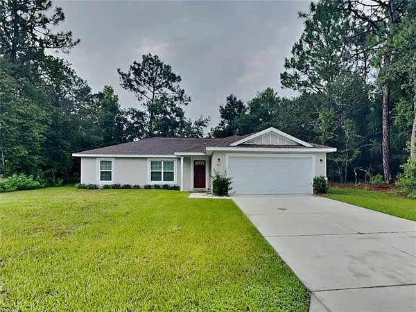a front view of house with yard and trees