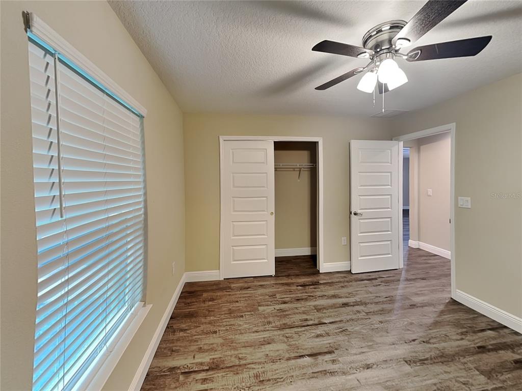 904 West Rum Place Dunnellon, FL 34434 - Photo 12 of 15 wooden floor in an empty room with a window
