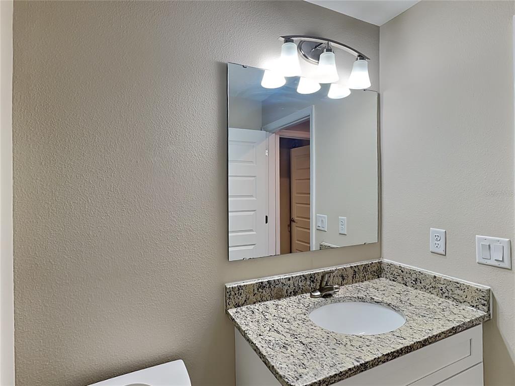 904 West Rum Place Dunnellon, FL 34434 - Photo 13 of 15 a bathroom with a granite countertop sink and a mirror