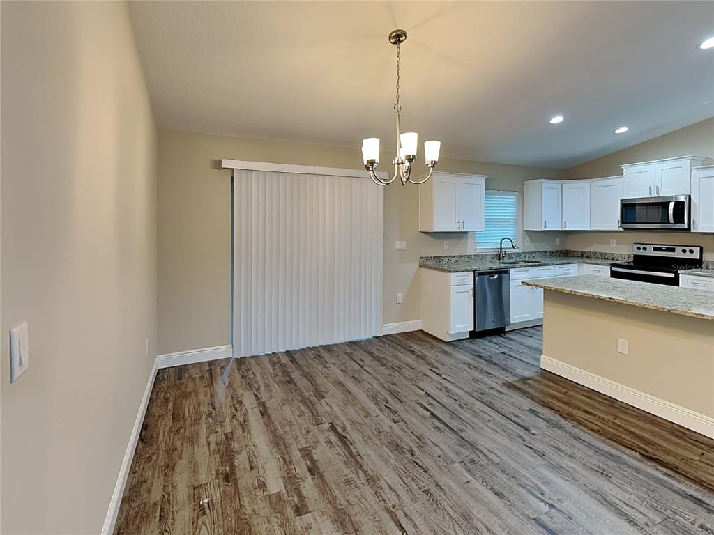 904 West Rum Place Dunnellon, FL 34434 - Photo 6 of 15 a view of a kitchen with a sink stainless steel appliances and cabinets