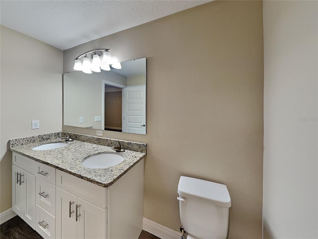 904 West Rum Place Dunnellon, FL 34434 - Photo 9 of 15 a bathroom with a granite countertop sink and a mirror