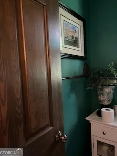 a living room with furniture tv and a floor to ceiling window