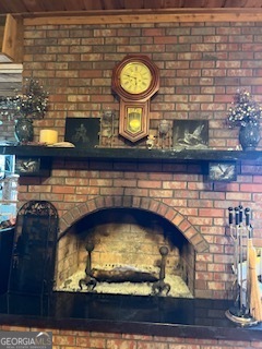 376 Paoli Road Carlton, GA 30627 - Photo 10 of 51 a fireplace with a clock on the wall