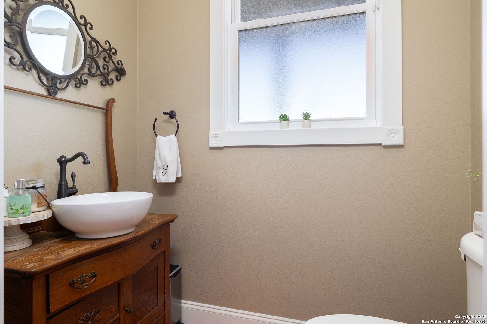42 Tower Road Boerne, TX 78006 - Photo 15 of 50 a bathroom with a granite countertop sink and a mirror