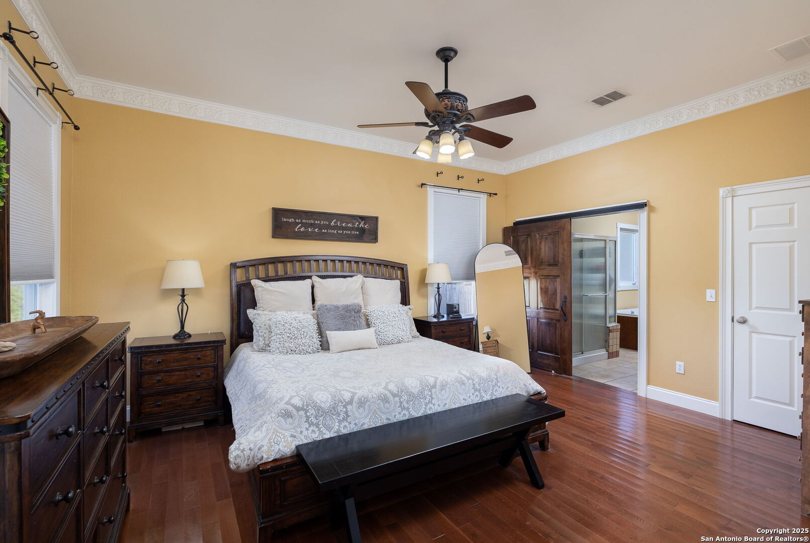 42 Tower Road Boerne, TX 78006 - Photo 19 of 50 a bedroom with a bed and a chandelier