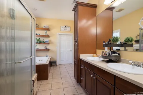 a bathroom with a tub sink and mirror