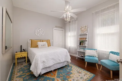 a bedroom with bed and wooden floor