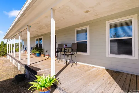 a balcony with chairs and with wooden floor