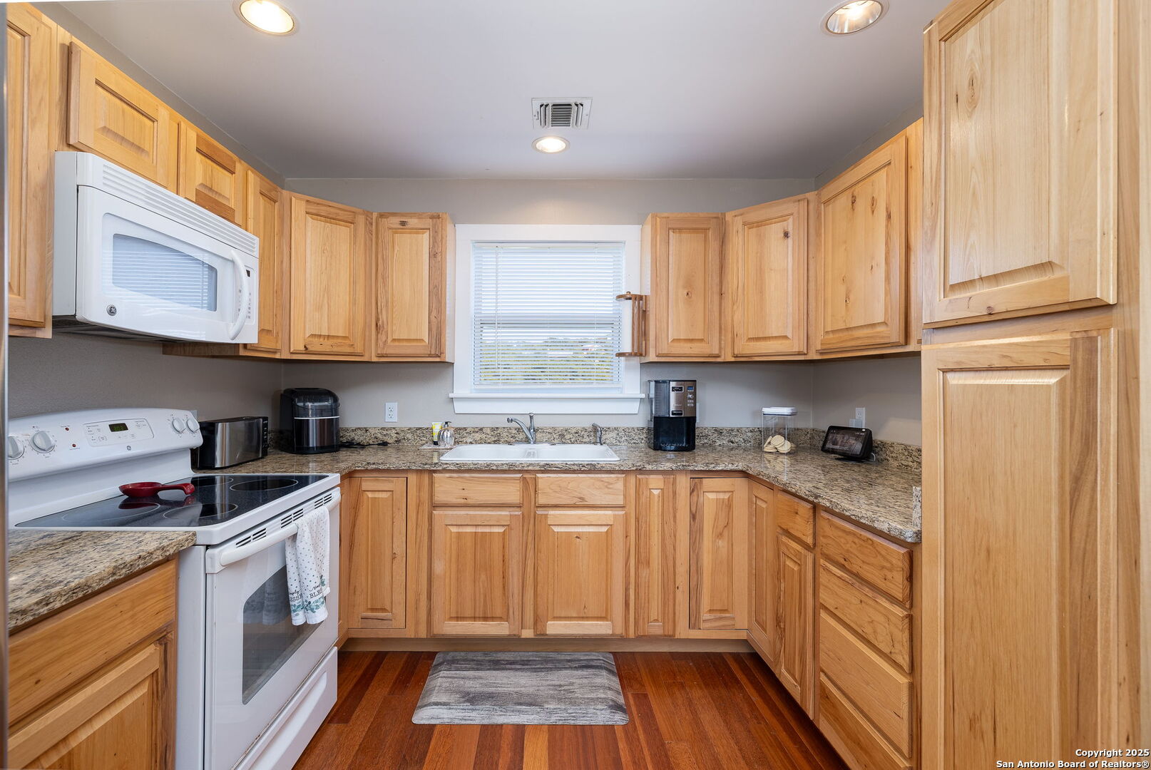 42 Tower Road Boerne, TX 78006 - Photo 33 of 50 a kitchen with stainless steel appliances granite countertop a stove a sink and a microwave