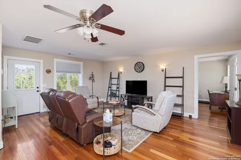 a living room with furniture and a wooden floor