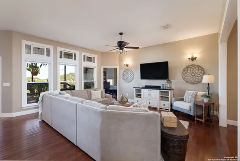 a living room with furniture a rug and a flat screen tv