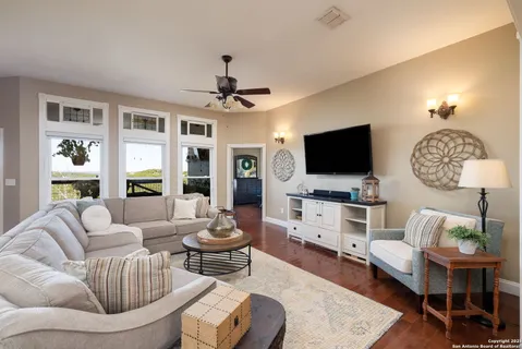 a living room with furniture and a wooden floor
