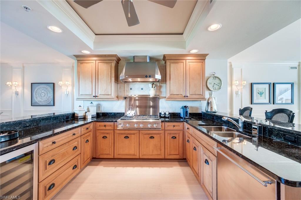 265 Indies Way, Unit 802 Naples, FL 34110 - Photo 16 of 50 a large kitchen with stainless steel appliances granite countertop a sink stove and cabinets