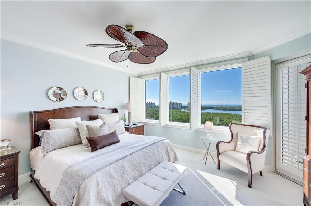 265 Indies Way, Unit 802 Naples, FL 34110 - Photo 19 of 50 a bedroom with a bed and a large window