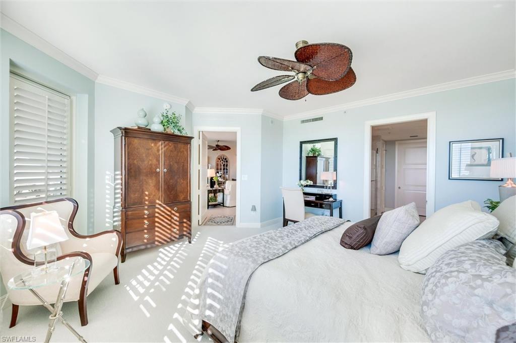 265 Indies Way, Unit 802 Naples, FL 34110 - Photo 20 of 50 a bedroom with a bed and closet with chair