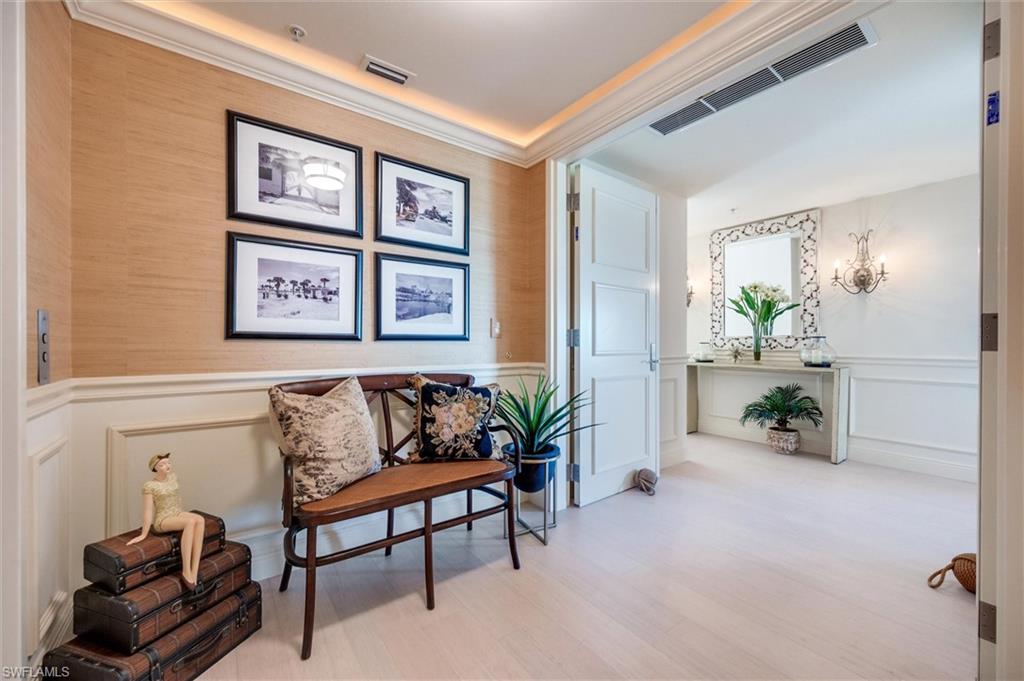 265 Indies Way, Unit 802 Naples, FL 34110 - Photo 2 of 50 a living room with furniture and paintings on the wall