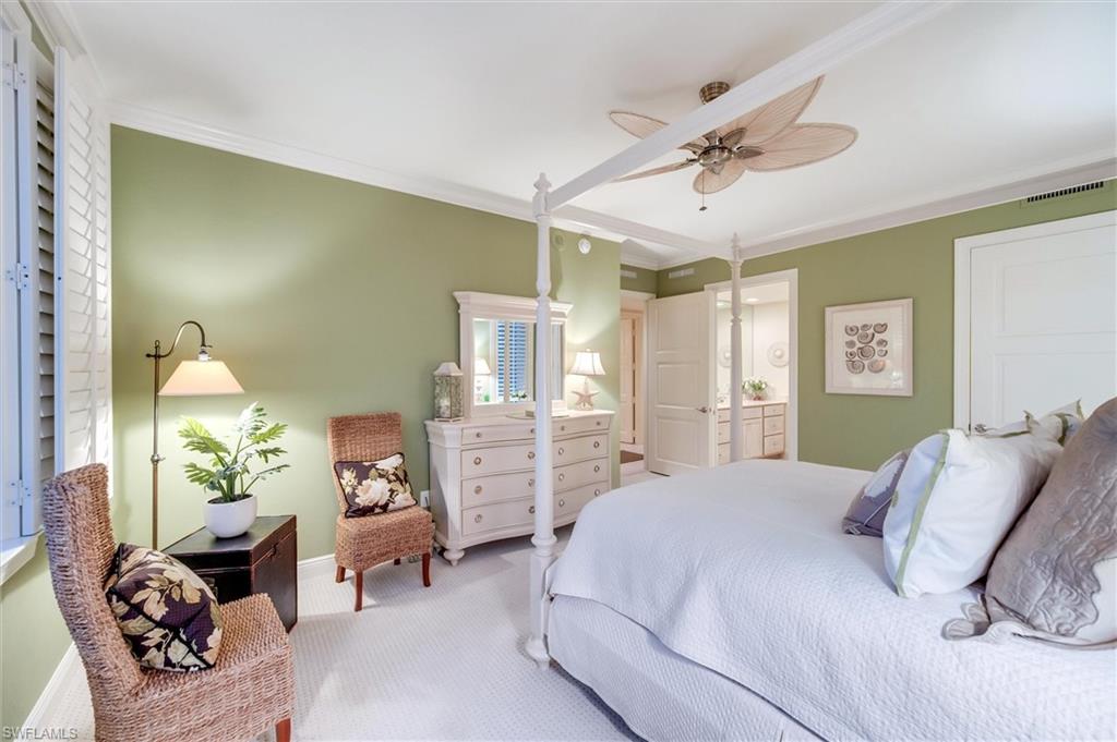 265 Indies Way, Unit 802 Naples, FL 34110 - Photo 31 of 50 a bedroom with a bed a chandelier and couch