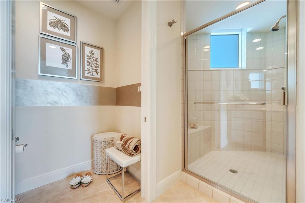 265 Indies Way, Unit 802 Naples, FL 34110 - Photo 33 of 50 a bathroom with a shower and a sink