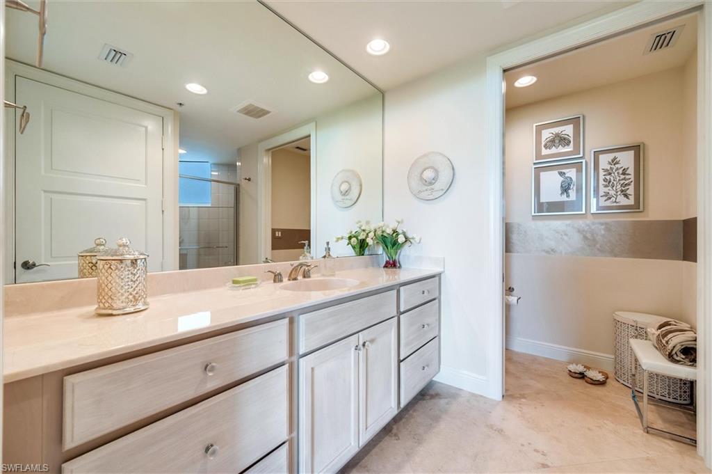 265 Indies Way, Unit 802 Naples, FL 34110 - Photo 34 of 50 a spacious bathroom with a double vanity sink and a mirror