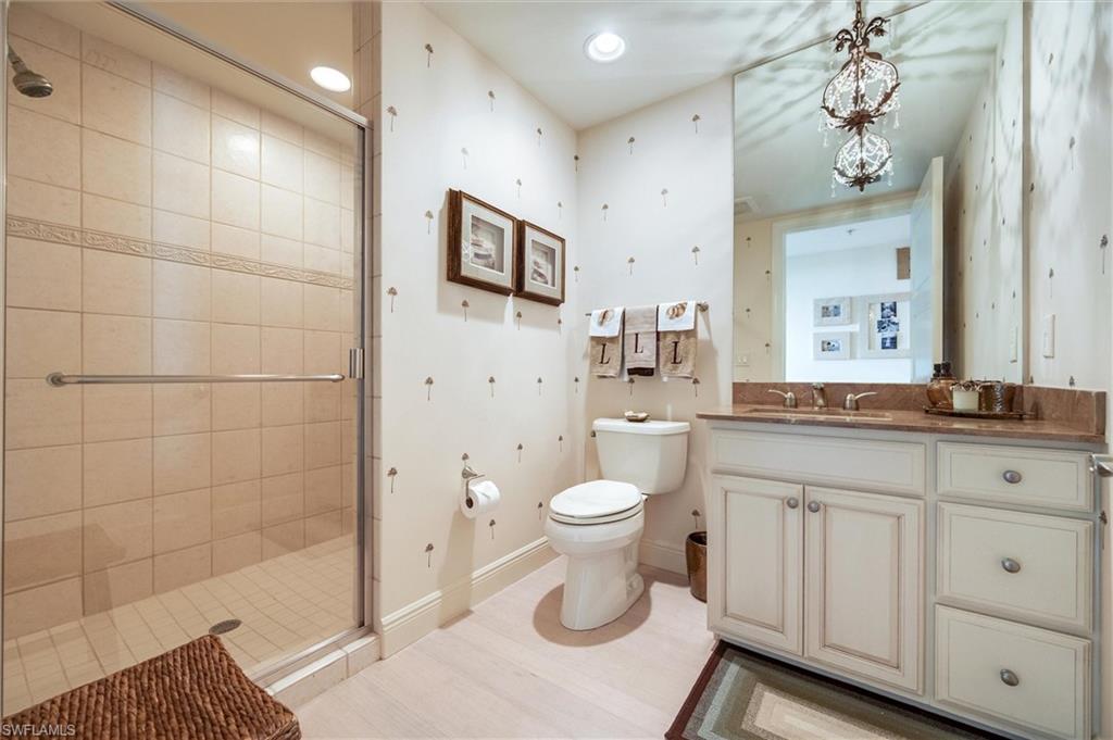 265 Indies Way, Unit 802 Naples, FL 34110 - Photo 35 of 50 a bathroom with a sink a toilet and shower