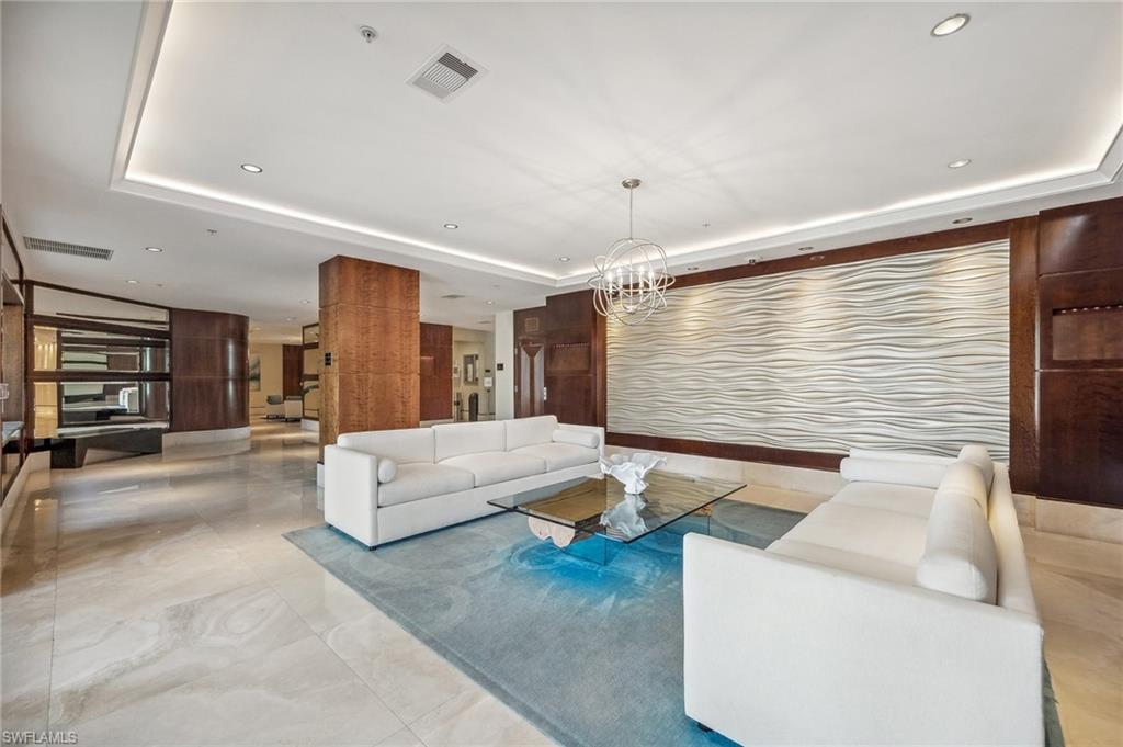 265 Indies Way, Unit 802 Naples, FL 34110 - Photo 43 of 50 a living room with furniture and a large window