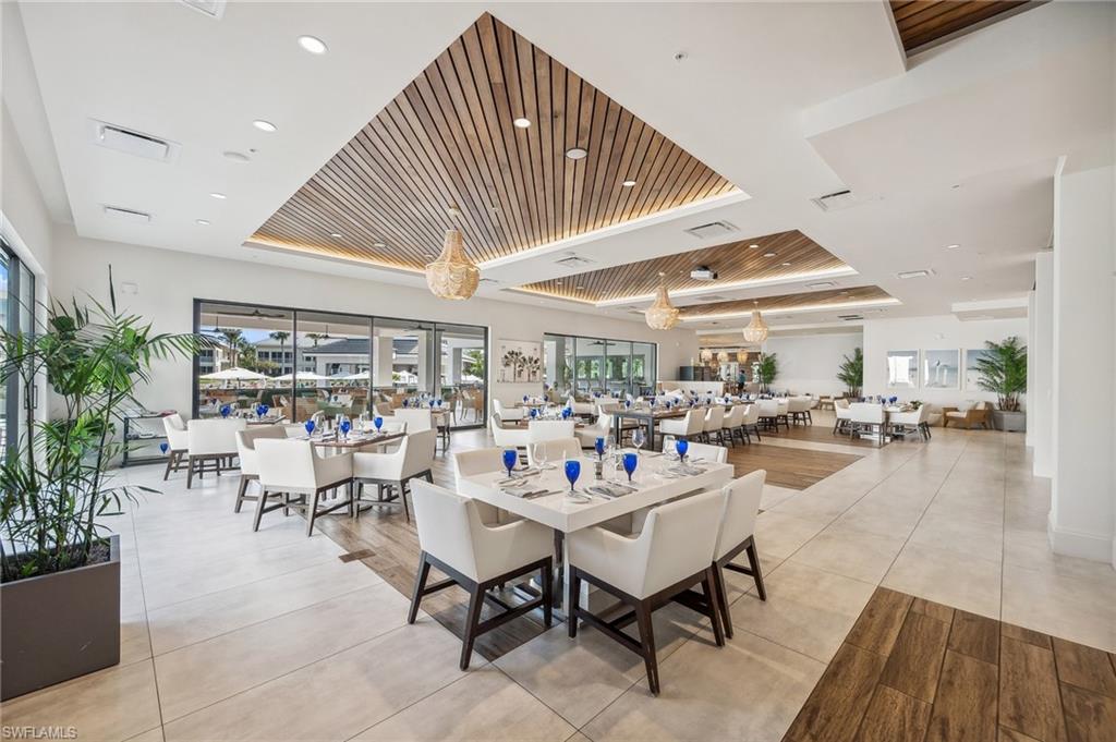 265 Indies Way, Unit 802 Naples, FL 34110 - Photo 49 of 50 a outdoor space with lots of tables a garden view and chairs