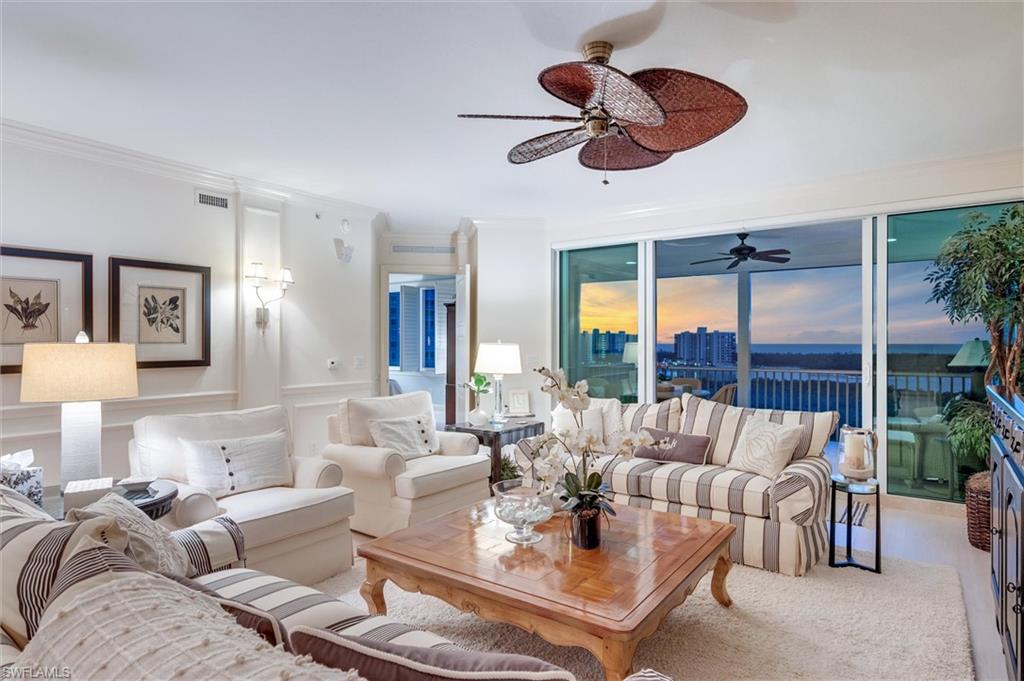 265 Indies Way, Unit 802 Naples, FL 34110 - Photo 5 of 50 a living room with furniture potted plant and a large window