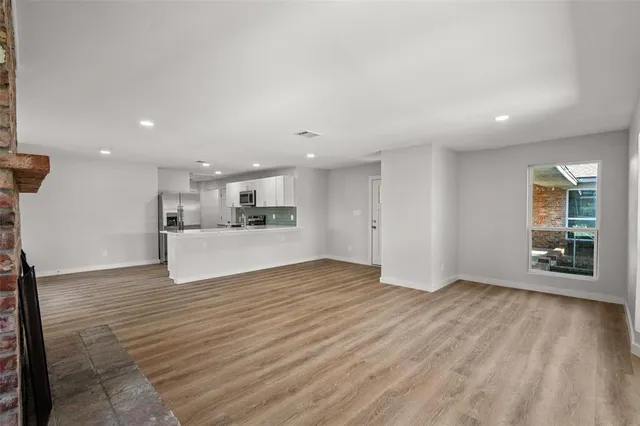 a view of kitchen and hall with wooden floor