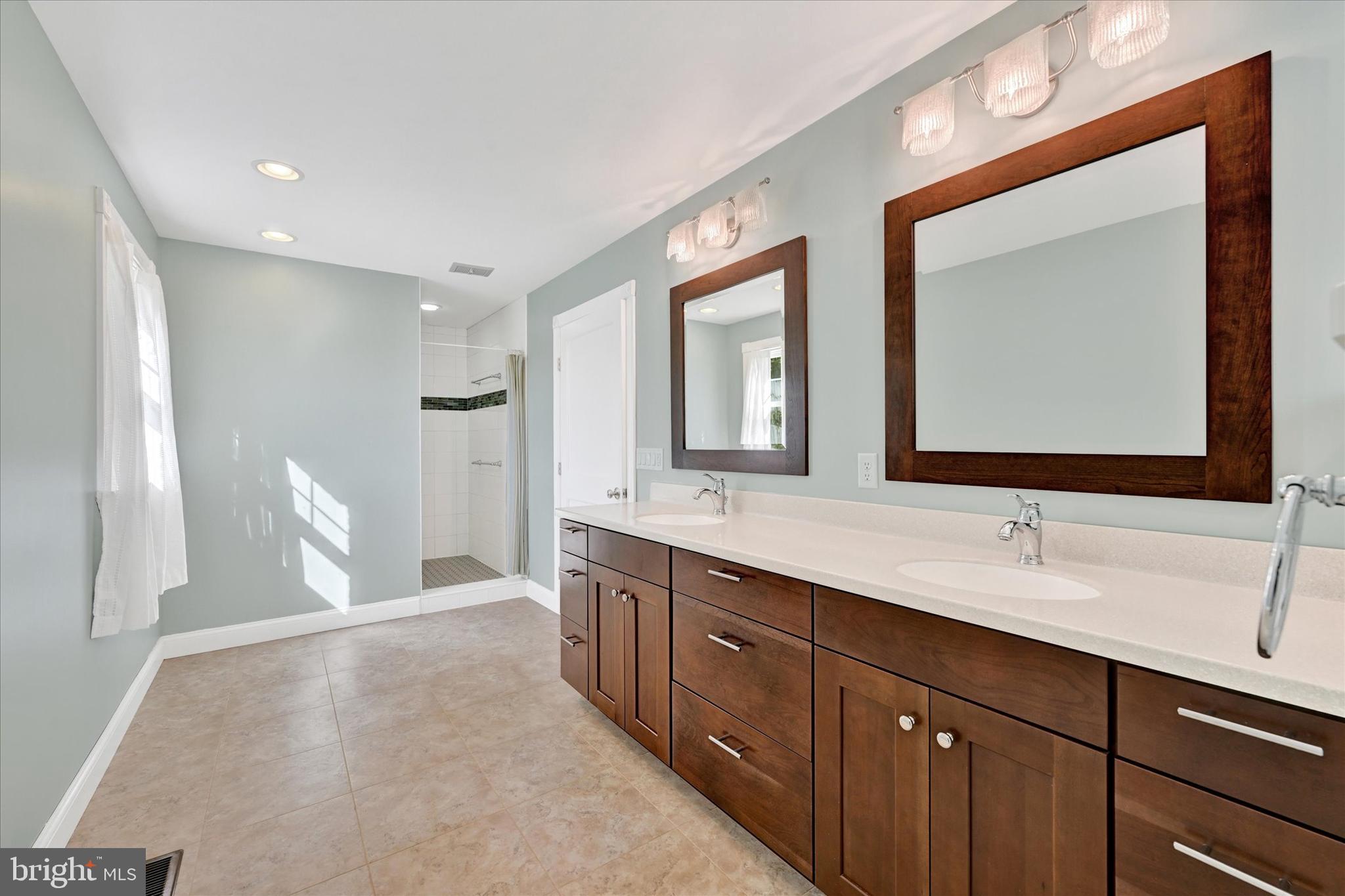 2524 Jennings Chapel Road Woodbine, MD 21797 - Photo 12 of 41 a en suite bathroom with a double vanity sink and a mirror