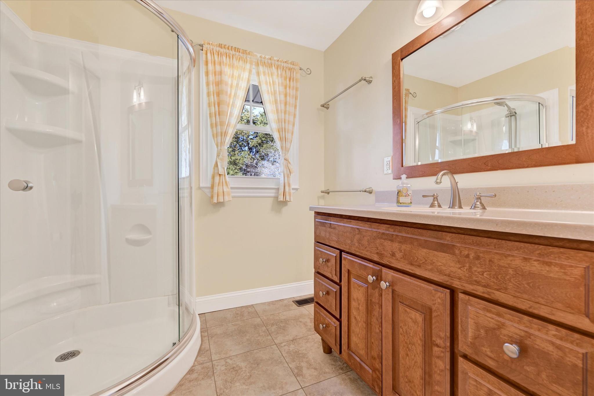 2524 Jennings Chapel Road Woodbine, MD 21797 - Photo 17 of 41 a bathroom with a granite countertop sink a mirror and a bathtub