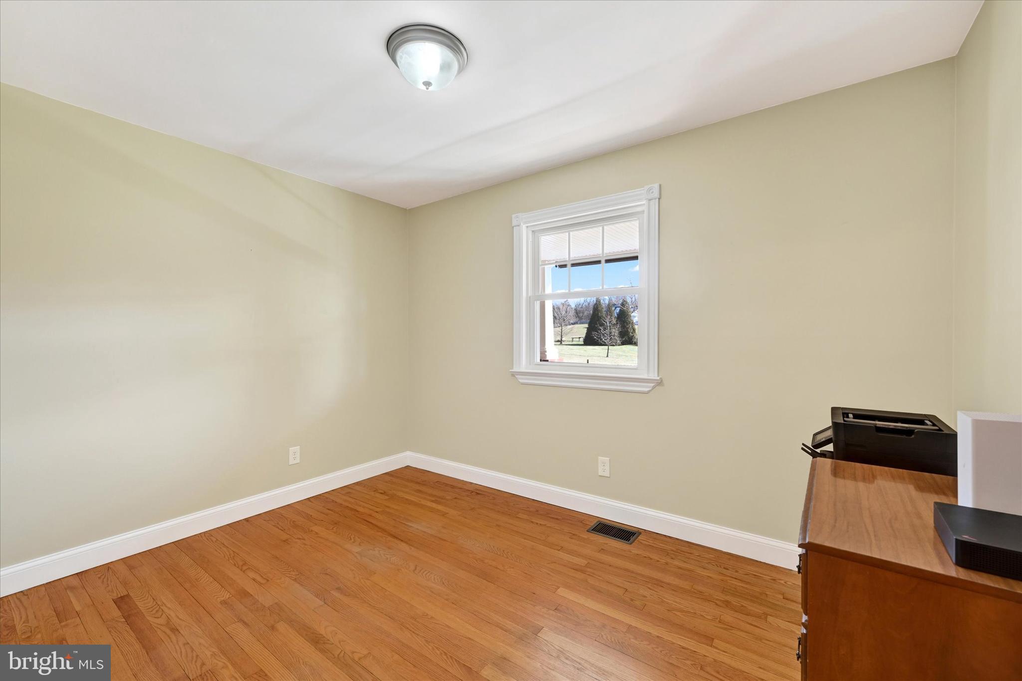 2524 Jennings Chapel Road Woodbine, MD 21797 - Photo 18 of 41 a view of a room with wooden floor and black countertop