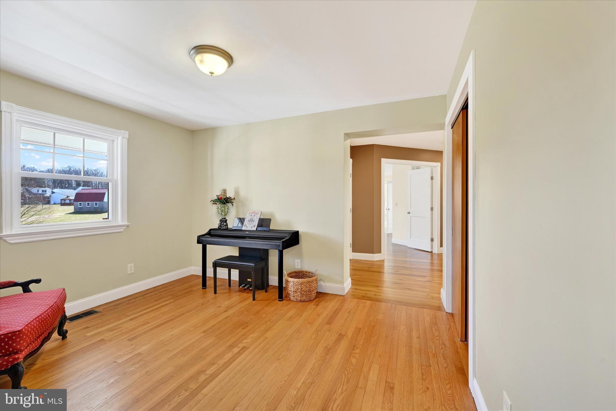2524 Jennings Chapel Road Woodbine, MD 21797 - Photo 20 of 41 a dining room with wooden floor a chandelier a glass table and windows