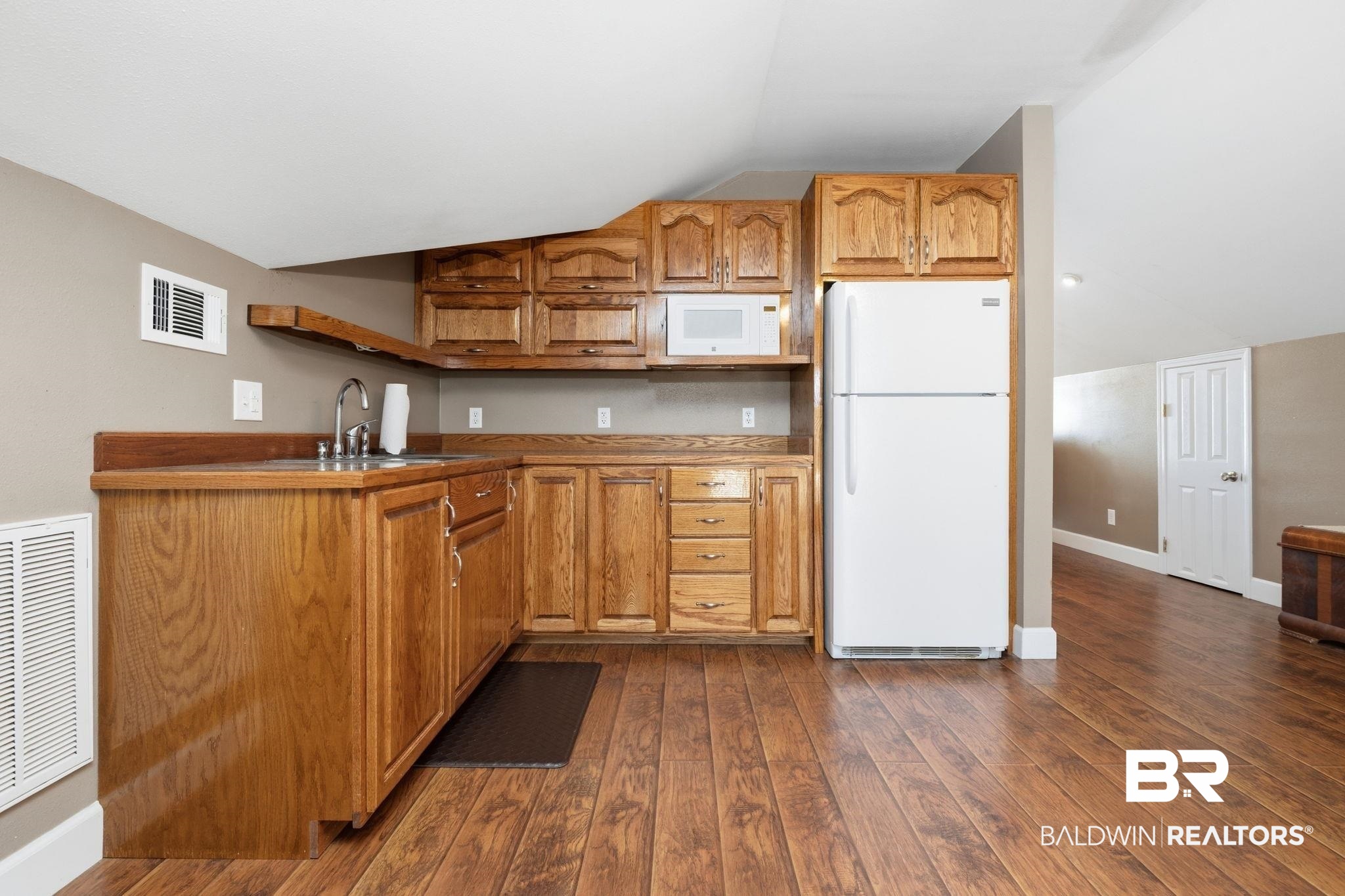 15025 Bellingrath Road Coden, AL 36523 - Photo 66 of 79 Kitchen featuring wood finish cabinetry, lofted ceiling, white appliances, open shelves, and dark wood-style flooring