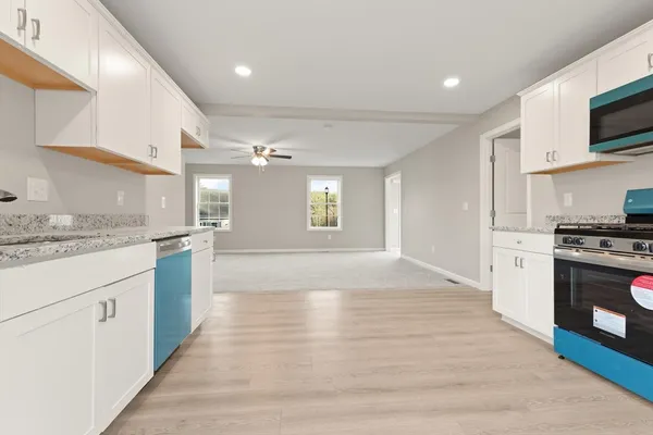 a view of kitchen with sink microwave and stove