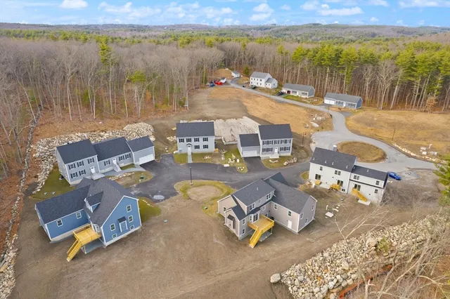 an aerial view of a swimming pool with outdoor seating