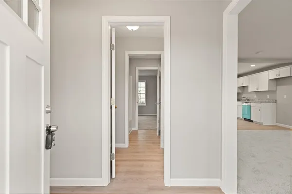 a view of a hallway with wooden shelves