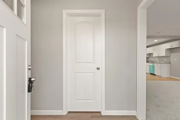 a view of a hallway with wooden floor